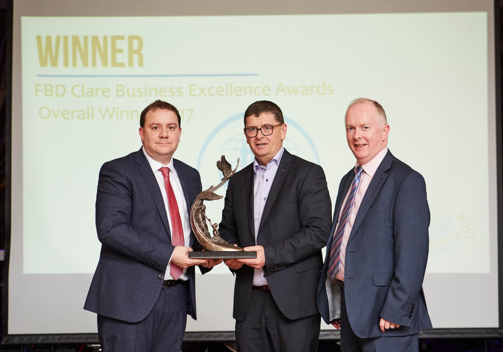 William Cahir President Ennis Chamber of Commerce, Louis Fay General Manager St Francis Credit Union (overall winner) and Mike Byrne MD of Acton BV. Photo: Mike Mulcaire