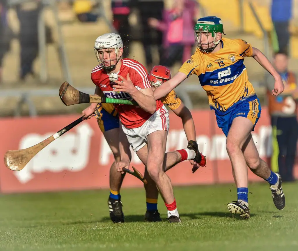 Clare's Billy Connors is beaten in a race for possession by Cork's David Griffin Photo: Martin Connolly